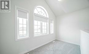 Oshawa (Taunton) apartment for rent - A room with a carpeted floor and three windows.