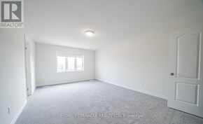 Oshawa (Taunton) apartment for rent - A room with a carpet floor and a window letting in light.