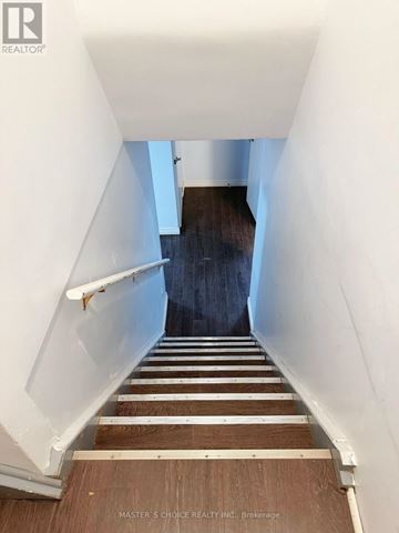 Richmond Hill (Crosby) apartment for rent - A kitchen with white cabinets and a black countertop.