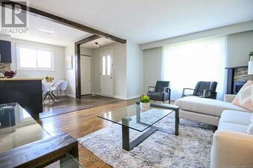 Hamilton (Berrisfield) multi-family for rent - A modern living room with a glass coffee table and a white sofa.