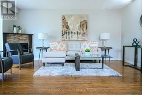 Hamilton (Berrisfield) multi-family for rent - A living room with a white couch and a painting on the wall.