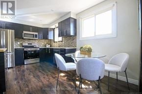 Hamilton (Berrisfield) multi-family for rent - A modern kitchen with a dining table set for four.