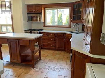 Niagara Falls (Morrison) apartment for rent - A kitchen with wooden cabinets and a white countertop.