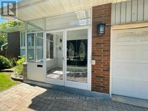 Niagara Falls (Morrison) apartment for rent - A house with a white garage door and a brick wall.
