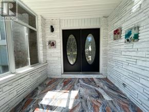Niagara Falls (Morrison) apartment for rent - A white brick wall with a glass door and a window.