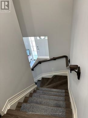Thorold (Hurricane/Merrittville) townhouse for rent - A staircase with a carpeted runner and wooden steps.