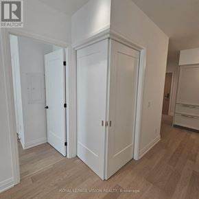 Toronto (Englemount-Lawrence) condo for rent - A white door is in a room with wood flooring.