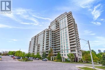 Toronto (Don Valley Village) condo for rent - A tall residential building with a parking lot in front.