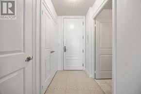 Toronto (Don Valley Village) condo for rent - A hallway with white doors and a tiled floor.