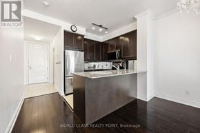 Toronto (Don Valley Village) condo for rent - A modern kitchen with dark wood floors and a central island.