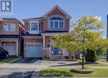Toronto (Cliffcrest) apartment for rent - A house with a tree in front of it.