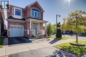 Toronto (Cliffcrest) apartment for rent - A house with a red brick facade and a white garage door.