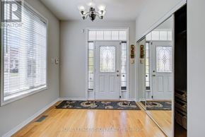 Toronto (Cliffcrest) apartment for rent - A hallway with a chandelier, two doors, and a window.
