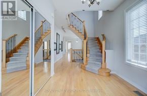Toronto (Cliffcrest) apartment for rent - A spacious hallway with a staircase and a chandelier.