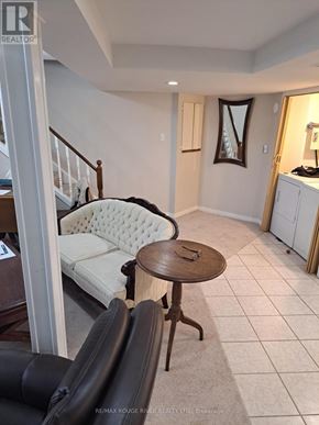 Toronto (Rouge) apartment for rent - A living room with a white sofa and a wooden table.
