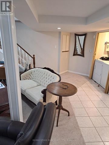Toronto (Rouge) apartment for rent - A living room with a white sofa and a wooden table.