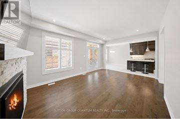 Oakville (Go Glenorchy) apartment for rent - A modern living room with a fireplace and a view of the kitchen.