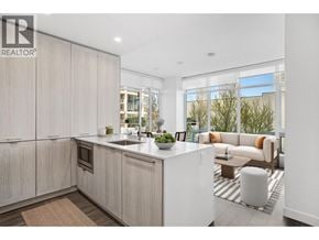 Burnaby apartment for rent - A modern kitchen with a large island and a view of the outdoors.