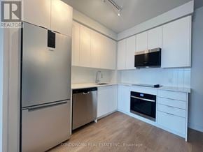 Vaughan (Concord) condo for rent - A kitchen with white cabinets and a stainless steel refrigerator.