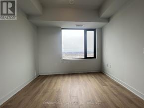 Vaughan (Concord) condo for rent - A room with a large window overlooking the beach.
