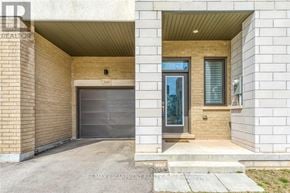 Oakville (Go Glenorchy) townhouse for rent - A modern house with a garage door and a glass door entrance.
