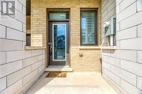 Oakville (Go Glenorchy) townhouse for rent - A modern front door with a glass window and a metal handle.
