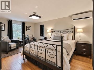 Burlington apartment for rent - A bedroom with a large bed and a window with curtains.