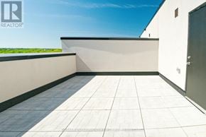 St. Catharines (E. Chester) townhouse for rent - A balcony with tiled flooring and a closed door.