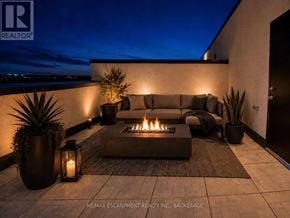 St. Catharines (E. Chester) townhouse for rent - A modern outdoor seating area with a lit fire pit.