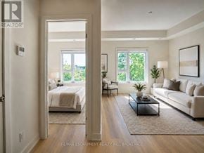 St. Catharines (E. Chester) townhouse for rent - A well-lit, spacious living room with a large bed in the background.
