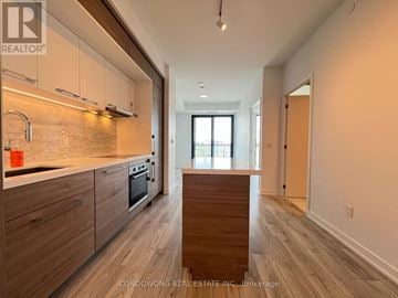 Toronto (Bayview Village) condo for rent - A kitchen with wooden floors and a counter top.
