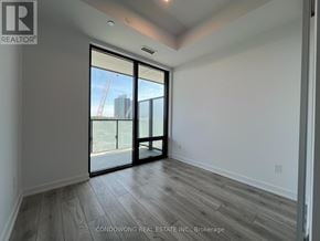 Toronto (Bayview Village) condo for rent - A room with a sliding glass door leading to a construction site.