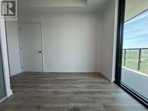 Toronto (Bayview Village) condo for rent - A room with a sliding glass door leading to a balcony.