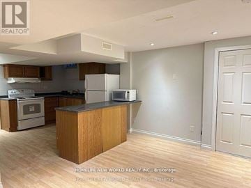 Richmond Hill (Rouge Woods) apartment for rent - A kitchen with wooden cabinets and a black countertop.