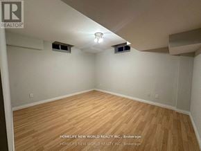 Richmond Hill (Rouge Woods) apartment for rent - A room with wooden flooring and white walls, with a light fixture on the ceiling.