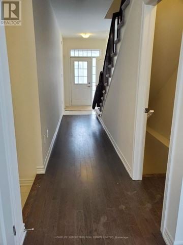 Brant (Paris) townhouse for rent - A hallway with wooden floors and white walls.