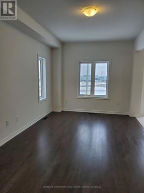 Brant (Paris) townhouse for rent - A room with wood flooring and two windows.