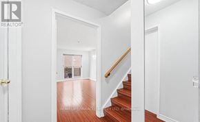 Toronto (West Hill) townhouse for rent - A hallway with a wooden floor and white walls.
