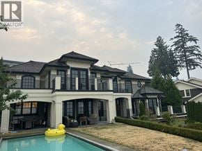 West Vancouver apartment for rent - A large house with a pool in front.