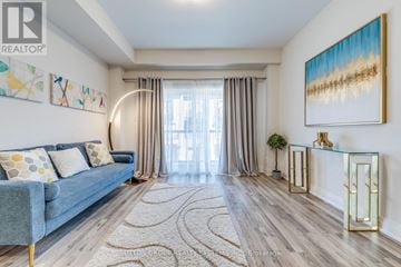 Toronto (Rustic) townhouse for rent - A living room with a blue couch and a painting on the wall.
