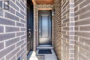 Toronto (Rustic) townhouse for rent - A door with a glass panel is set in a brick wall.
