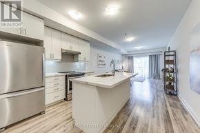 Toronto (Rustic) townhouse for rent - A modern kitchen with a stainless steel refrigerator and wooden flooring.