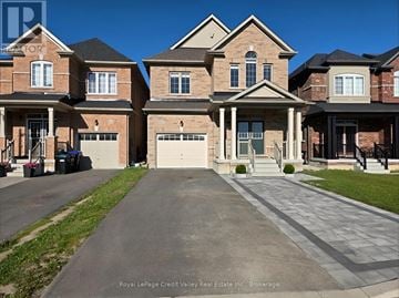 Innisfil (Alcona) apartment for rent - A large, well-maintained house with a driveway in front.