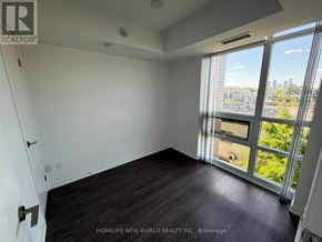 Toronto (Little Portugal) condo for rent - A room with a sliding glass door leading to a balcony with a view of the city.