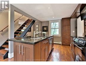 Burlington (Bayview) apartment for rent - A modern kitchen with wooden cabinets and a marble countertop.