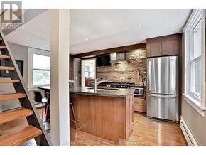 Burlington (Bayview) apartment for rent - A modern kitchen with a wooden island and stainless steel appliances.