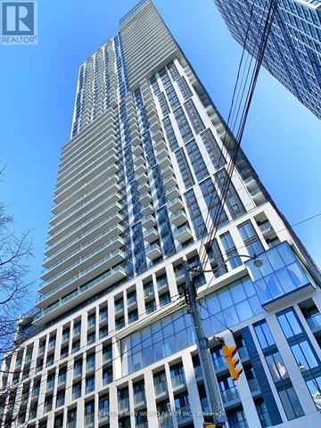 Toronto (Church-Yonge Corridor) condo for rent - A tall building with many windows and a sign that says REALTOR.