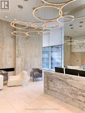 Toronto (Church-Yonge Corridor) condo for rent - A reception area with a marble counter and a light fixture.