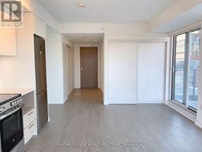 Toronto (Church-Yonge Corridor) condo for rent - A spacious kitchen and living room with a stainless steel refrigerator and oven.