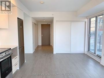 Toronto (Church-Yonge Corridor) condo for rent - A spacious kitchen and living room with a stainless steel refrigerator and oven.